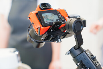 A camera takes a video for a cooks or pastry chef in kitchen.