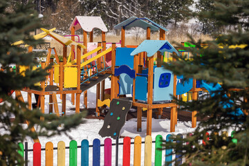 Playground In the mountain park. Winter forest and playground.