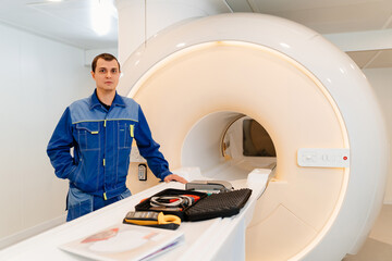 installer engineer of mri apparatus with tools near scanner