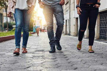 These streets were made for walking. Cropped shot of three people walking together in the city.