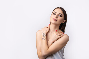 Fototapeta premium Beautiful smiling woman with clean skin, natural make-up and white teeth on a gray background