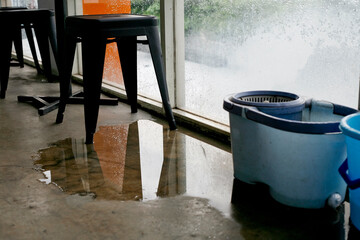 water puddle on floor due to leakage in the rainy day - obrazy, fototapety, plakaty