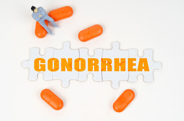 On the white surface of the tablet, a miniature human figure and puzzles with the inscription - GONORRHEA