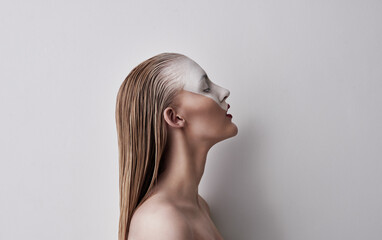 Be whatever you feel like. Shot of a beautiful woman wearing face paint and red lipstick against a plain background.
