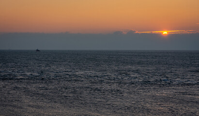 Beautiful sunset on the North Sea as seen from the village of Huisduinen, Province North Holland, The Netherlands