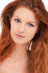 Perfection personified. Pretty red-headed woman with amazing skin looking engagingly at the camera.