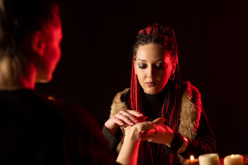 The seer sees the future by touching his hand and the hand of a person who wants to know his future.