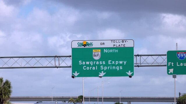 Street sign on the highway of Florida showing Coral Springs and Sawgrass Expressway - travel photography