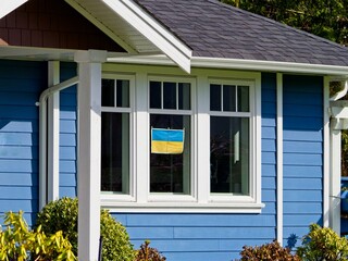 Fototapeta na wymiar Banner with Ukrainian flag decorating the house in sign of support of Ukraine 