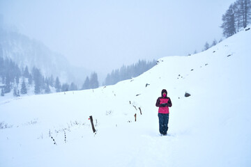 High mountains under snow in the winter. Ski resort. Skiers descend from the mountain.