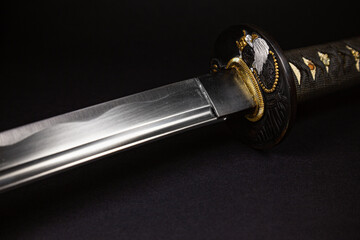 Japanese katana samurai sword with a pattern on a black background