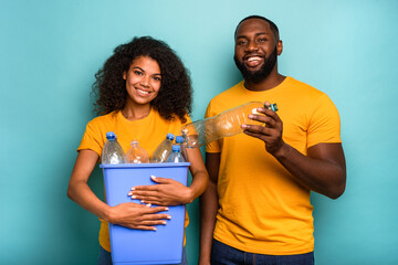 Couple hold a plastic container with bottles as concept of ecology and recycling