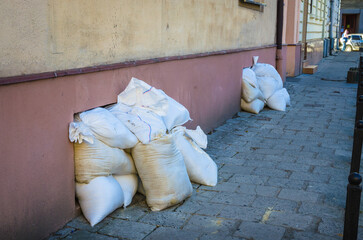 Bags with sand near shelter in old town Lviv, Ukraine. Defense from russian agression