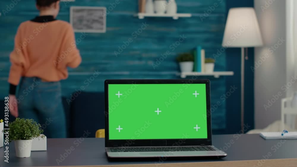 Poster laptop display with green screen background on desk, used to create mockup template and blank copy s