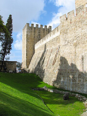 The outside castle walls of Sao Jorge castle (Castelo de São Jorge in Portuguese) in Lisbon,...