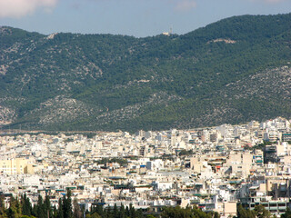 Athens, Greece - A panoramic view of the urban sprawl of Athens, with the backdrop of a large hill in the background.  Image has copy space.