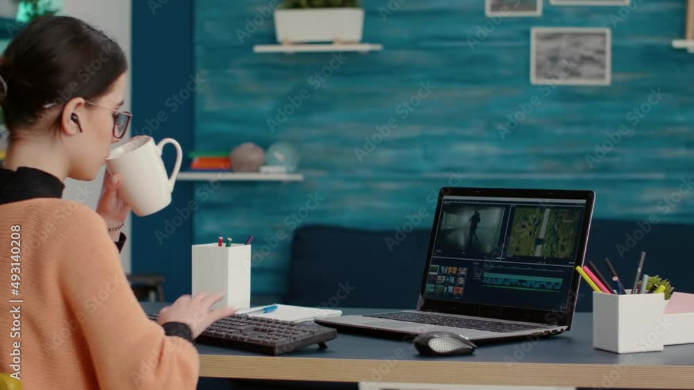 Poster content creator creating film montage with video editing software on laptop, working on online cours