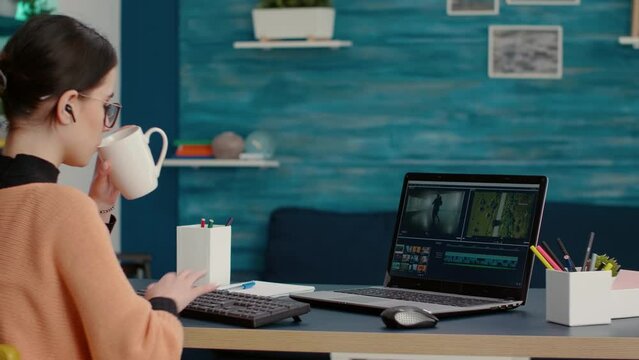 Content creator creating film montage with video editing software on laptop, working on online course assignment from home. Media designer developing movie making production on app.