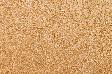 Full frame of artifical fabric with an orange homogeneous texture