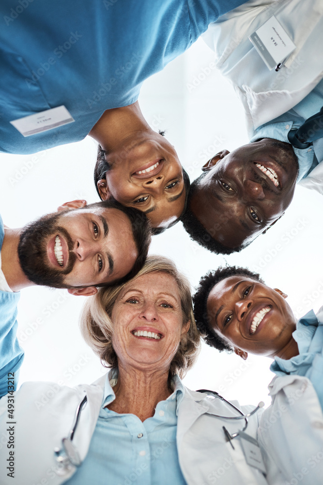 Canvas Prints Working cohesively to provide quality healthcare for all. Portrait of a group of medical practitioners standing together in a huddle.