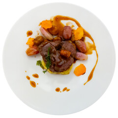 Delicate roasted veal loin marinated with rosemary served with vegetable garnish of baked chestnuts, shallots and sweet potatoes. Italian cuisine. Isolated over white background