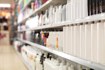 Various of haircare cosmetics for sale on shelves of cosmetic shop, selective focus