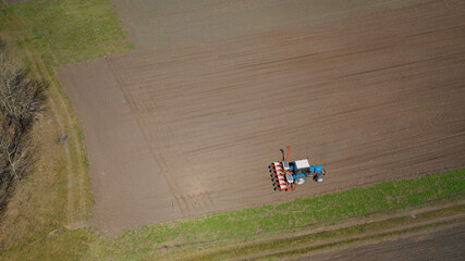 Farming: a farmer on a tractor works the field before sowing