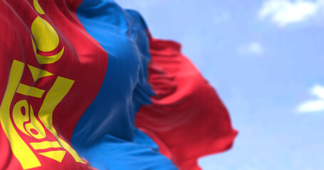 Detail of the national flag of Mongolia waving in the wind on a clear day