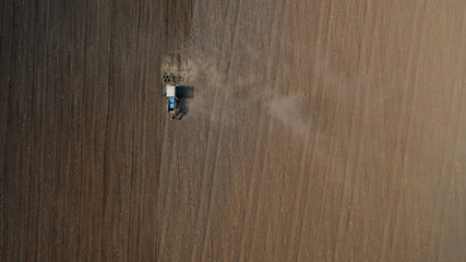 Farming: a farmer on a tractor works the field before sowing