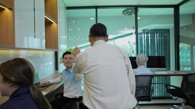 Business concept of 4k Resolution. Group of Asian businessmen rejoicing together in the office. Coordinating the hands of the department's employees to join forces