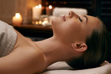 Being pampered from top to toe. A young woman lying with her eyes closed on a massage bed.