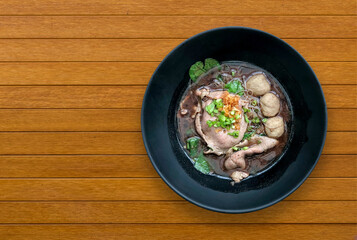 Top view shot of Noodles with beef and pork balls with soup Thai style on wooden table and free space,