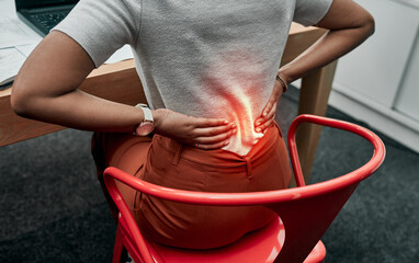 Pay attention to your posture to prevent pain. Closeup shot of an unrecognisable businesswoman suffering with back pain while working in an office.