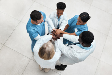 Fostering teamwork to improve patient outcomes. High angle shot of a group of medical practitioners...