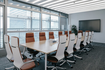 	
Business meeting room or Board room interiors.Orange chairs and wood-grain conference tables...