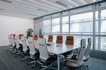 	
Business meeting room or Board room interiors.Orange chairs and wood-grain conference tables...