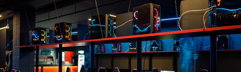Photo of powerful computers for esports online competitions and streaming chairs in interior of dark, empty internet cafe © Yaroslav Astakhov