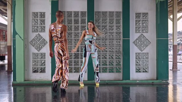 Fashion Models Walking To Camera In Train Station