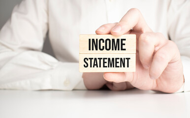 Income Statement text on white paper on the wood table