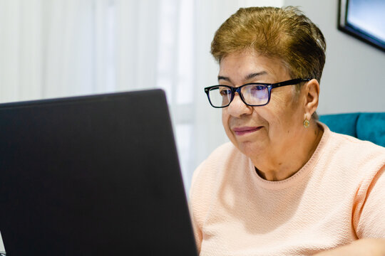 close up of an older latina woman using a laptop computer