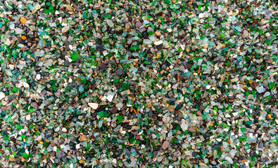 Glass Bay in Vladivostok. Sea-polished colored glass on the beach. Background, texture