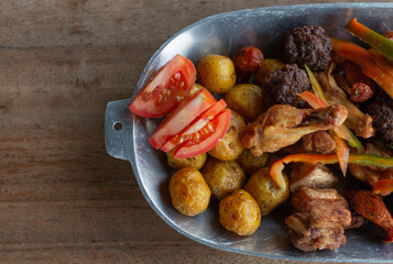 fried or chopped, traditional Colombian food, composed of fried meatballs, chicken, creole potato, pork rinds, banana, lemon and tomato