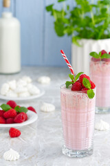 Raspberry milkshake non alcoholic cocktail. Raspberry smoothie weight loss concept. Berry smoothie in a glass on the breakfast
