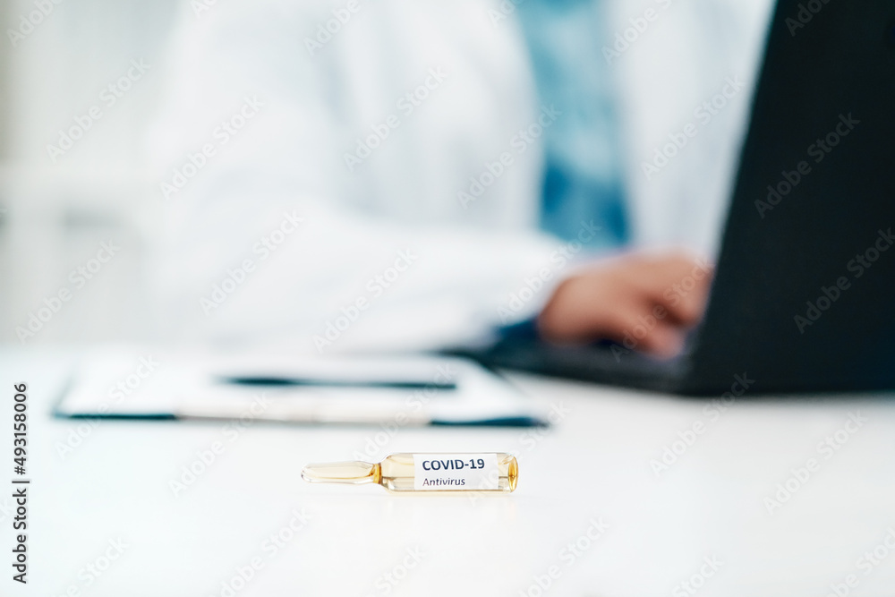 Poster The hunt is on to save humanity. Cropped shot of a scientist using a laptop while working on a coronavirus cure in a laboratory.