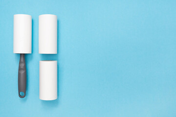 Sticky Hair Removal Roller. Copy space. Place for text. Lint Roller Dog, Cat, Animal, Hair Remover. Pet Fur, Fuzz. Blue background. Flat lay. Top view.