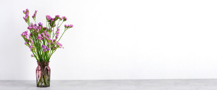 Flower bouquet in glass vase on table background with copy space , Banner for mock up, template