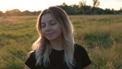 portrait of a beautiful European girl with loose hair against the background of nature. selective focus