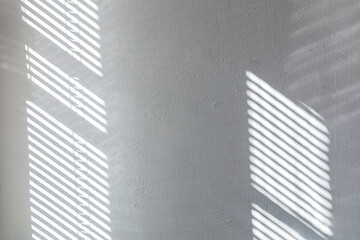 Fototapeta na wymiar shadow overlay from window on white texture wall. sunlight background.