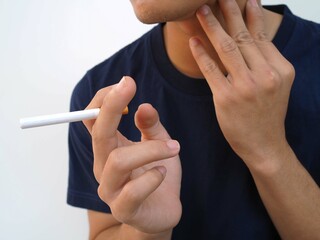 Neck of young male smoker have a sore throat. caused by smoking, cancer, throat cancer concept.