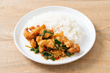 Fototapeta premium stir-fried fried fish with basil and chili in thai style topped on rice